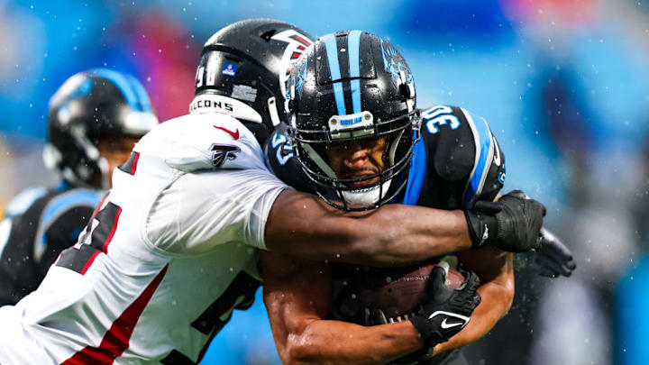 CHARLOTTE, NC - DECEMBER 17: Zach Harrison #96 of the Atlanta Falcons tackles Chuba Hubbard #30 of the Carolina Panthers during an NFL game at Bank of America Stadium in Charlotte, North Carolina on Dec 17, 2023.