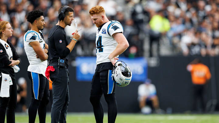LAS VEGAS, NEVADA - SEPTEMBER 22: (L-R) Head coach Dave Canales of the Carolina Panthers speaks with quarterback Andy Dalton #14 on the field during the third quarter of an NFL football game against the Las Vegas Raiders, at Allegiant Stadium on September 22, 2024 in Las Vegas, Nevada.