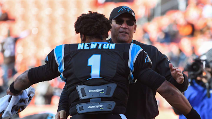 CLEVELAND, OH - DECEMBER 9, 2018: Head coach Ron Rivera of the Carolina Panthers embraces quarterback Cam Newton #1 prior to a game against the Cleveland Browns on December 9, 2018 at FirstEnergy Stadium in Cleveland, Ohio. Cleveland won 26-20. CLEVELAND, OH - DECEMBER 9, 2018: Head coach Ron Rivera of the Carolina Panthers embraces quarterback Cam Newton #1 prior to a game against the Cleveland Browns on December 9, 2018 at FirstEnergy Stadium in Cleveland, Ohio. Cleveland won 26-20.