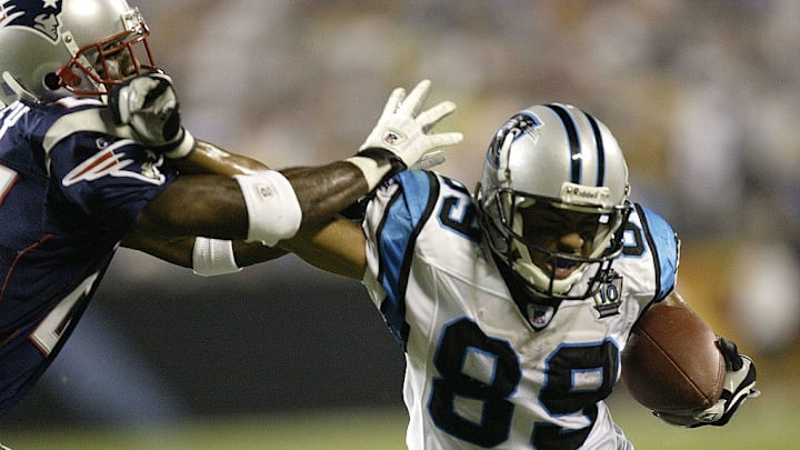 CHARLOTTE, NC - AUGUST 28: Terrell Buckley #27 of the New England Patriots tries to stop Steve Smith #89 of the Carolina Panthers on August 28, 2004 at Bank of America Stadium in Charlotte, North Carolina.