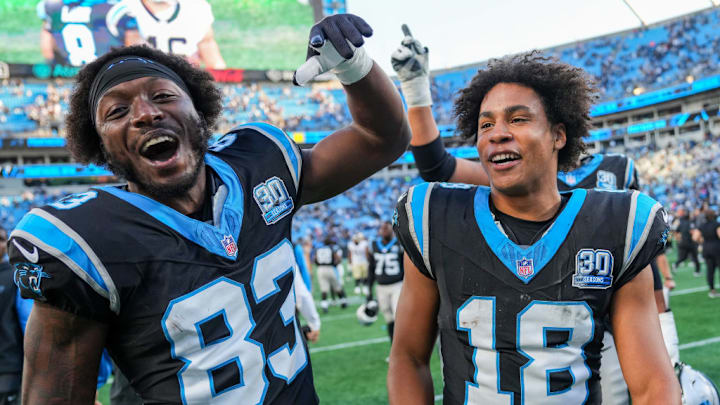 CHARLOTTE, NORTH CAROLINA - NOVEMBER 03: David Moore #83 and Jalen Coker #18 of the Carolina Panthers celebrates after a win over the against the New Orleans Saints at Bank of America Stadium on November 03, 2024 in Charlotte, North Carolina.