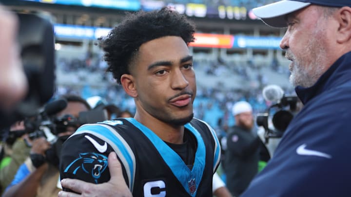 CHARLOTTE, NORTH CAROLINA - NOVEMBER 19: Bryce Young #9 of the Carolina Panthers and head coach Mike McCarthy of the Dallas Cowboys embrace after the game at Bank of America Stadium on November 19, 2023 in Charlotte, North Carolina.