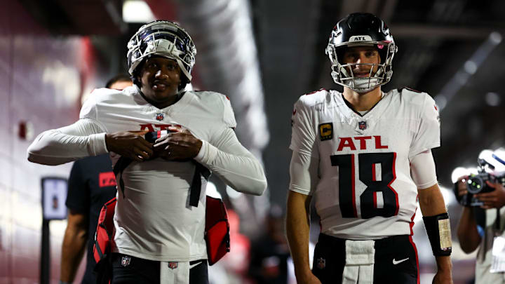 TAMPA, FLORIDA - OCTOBER 27: Michael Penix Jr. #9 and Kirk Cousins #18 of the Atlanta Falcons walk through the tunnel prior to an NFL football game against the Tampa Bay Buccaneers at Raymond James Stadium on October 27, 2024 in Tampa, Florida.
