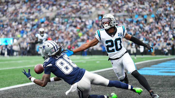 CHARLOTTE, NORTH CAROLINA - DECEMBER 15: CeeDee Lamb #88 of the Dallas Cowboys catches a touchdown pass against Jordan Fuller #20 of the Carolina Panthers during the second quarter at Bank of America Stadium on December 15, 2024 in Charlotte, North Carolina.