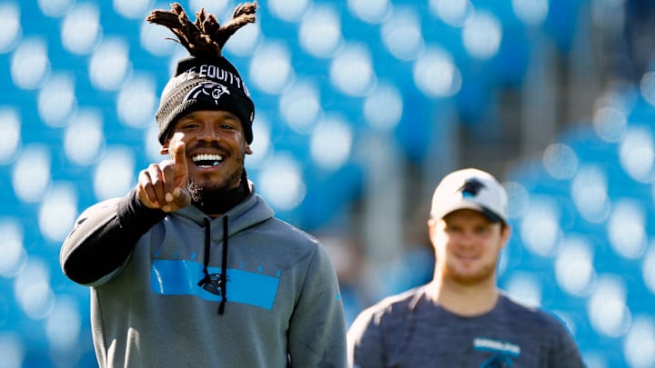 CHARLOTTE, NORTH CAROLINA - DECEMBER 26: Cam Newton #1 and Sam Darnold #14 of the Carolina Panthers look on prior to the first half of the game against the Tampa Bay Buccaneers at Bank of America Stadium on December 26, 2021 in Charlotte, North Carolina. 