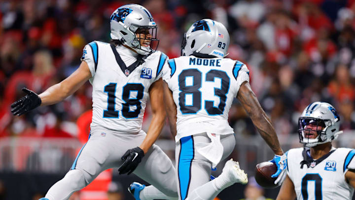 ATLANTA, GEORGIA - JANUARY 05: David Moore #83 of the Carolina Panthers celebrates with teammate Jalen Coker #18 after scoring a touchdown against the Atlanta Falcons during the third quarter at Mercedes-Benz Stadium on January 05, 2025 in Atlanta, Georgia. 