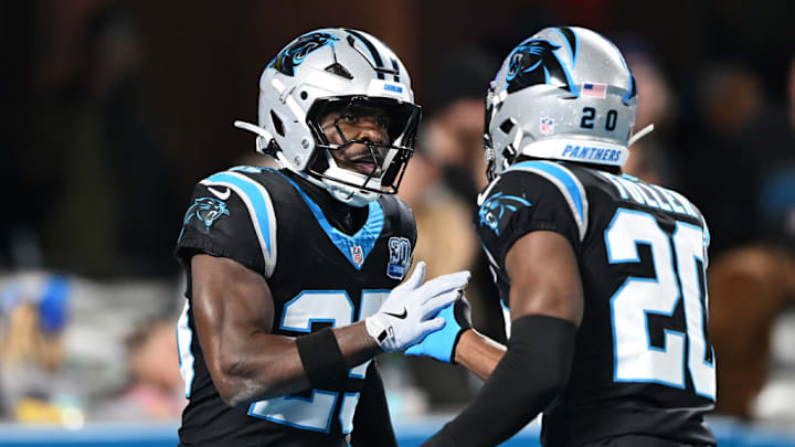 CHARLOTTE, NORTH CAROLINA - DECEMBER 01: Xavier Woods #25 of the Carolina Panthers celebrates an interception with Jordan Fuller #20 during the third quarter against the Tampa Bay Buccaneers at Bank of America Stadium on December 01, 2024 in Charlotte, North Carolina.