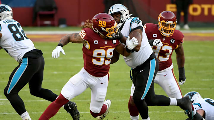 LANDOVER, MARYLAND - DECEMBER 27: Chase Young #99 of the Washington Football Team rushes the passer against Trent Scott #73 of the Carolina Panthers during the game at FedExField on December 27, 2020 in Landover, Maryland.