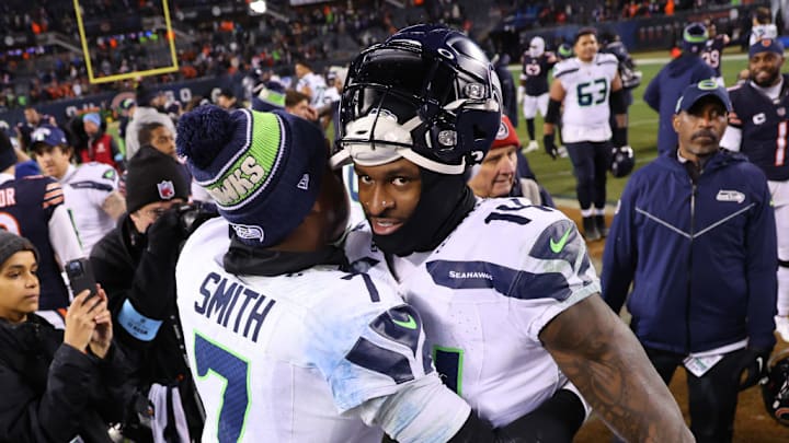 CHICAGO, ILLINOIS - DECEMBER 26: Geno Smith #7 and DK Metcalf #14 of the Seattle Seahawks embrace after the game against the Chicago Bears at Soldier Field on December 26, 2024 in Chicago, Illinois. 