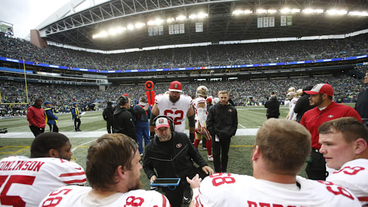 SEATTLE, WA - DECEMBER 2: Offensive Line Coach John Benton of the San Francisco 49ers talks with the offensive line on the sideline during the game against the Seattle Seahawks at CenturyLink Field on December 2, 2018 in Seattle, Washington. The Seahawks defeated the 49ers 43-16. 