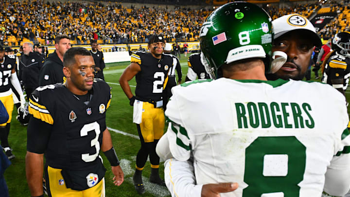 PITTSBURGH, PENNSYLVANIA - OCTOBER 20: Russell Wilson #3 and Justin Fields #2 of the Pittsburgh Steelers look on as head coach Mike Tomlin of the Pittsburgh Steelers and Aaron Rodgers #8 of the New York Jets embrace after the game at Acrisure Stadium on October 20, 2024 in Pittsburgh, Pennsylvania.