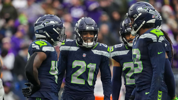 SEATTLE, WASHINGTON - DECEMBER 22: Devon Witherspoon #21 of the Seattle Seahawks talks with teammates during the third quarter against the Minnesota Vikings at Lumen Field on December 22, 2024 in Seattle, Washington. 