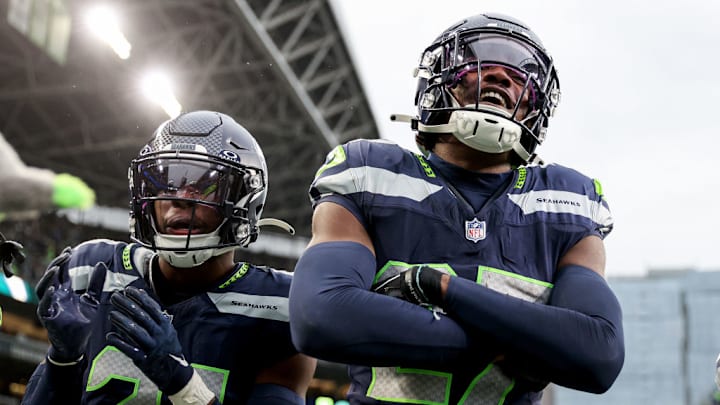 SEATTLE, WASHINGTON - NOVEMBER 12: Devon Witherspoon #21 and Riq Woolen #27 of the Seattle Seahawks celebrate a turnover against the Washington Commanders during the third quarter at Lumen Field on November 12, 2023 in Seattle, Washington.