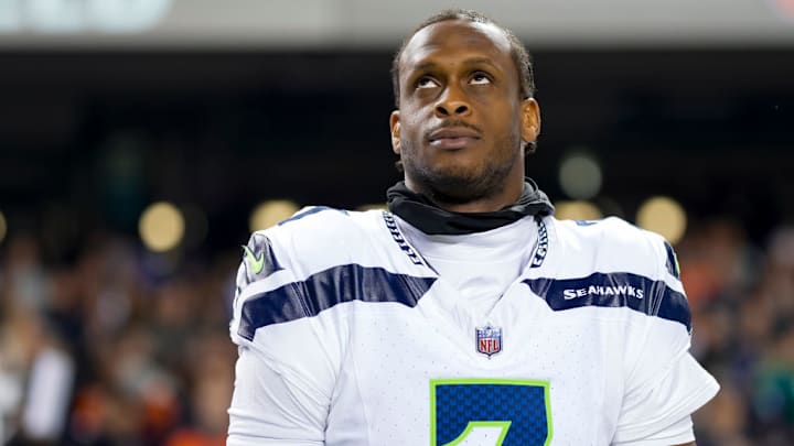 CHICAGO, ILLINOIS - DECEMBER 26: Quarterback Geno Smith #7 of the Seattle Seahawks stands on the sidelines during the national anthem prior to an NFL football game against the Chicago Bears, at Soldier Field on December 26, 2024 in Chicago, Illinois. CHICAGO, ILLINOIS - DECEMBER 26: Quarterback Geno Smith #7 of the Seattle Seahawks stands on the sidelines during the national anthem prior to an NFL football game against the Chicago Bears, at Soldier Field on December 26, 2024 in Chicago, Illinois.