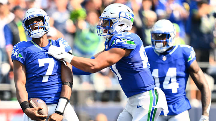 SEATTLE, WASHINGTON - SEPTEMBER 08: Geno Smith #7 and Noah Fant #87 of the Seattle Seahawks celebrate after Smith's rushing touchdown during the second quarter against the Denver Broncos at Lumen Field on September 08, 2024 in Seattle, Washington. 