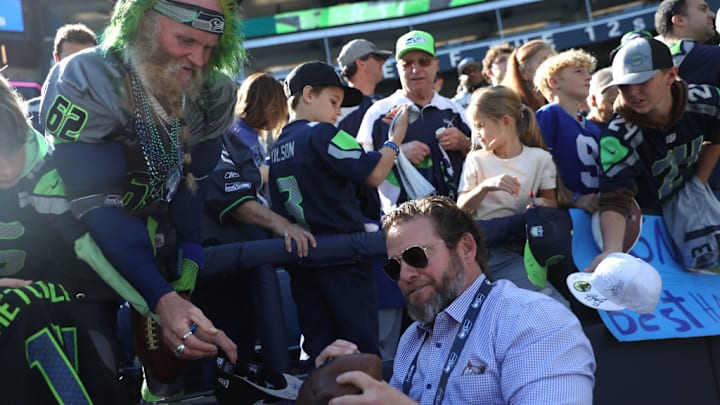 SEATTLE, WASHINGTON - OCTOBER 06: General manager John Schneider of the Seattle Seahawks sings autographs prior to a game against the New York Giants at Lumen Field on October 06, 2024 in Seattle, Washington. SEATTLE, WASHINGTON - OCTOBER 06: General manager John Schneider of the Seattle Seahawks sings autographs prior to a game against the New York Giants at Lumen Field on October 06, 2024 in Seattle, Washington.