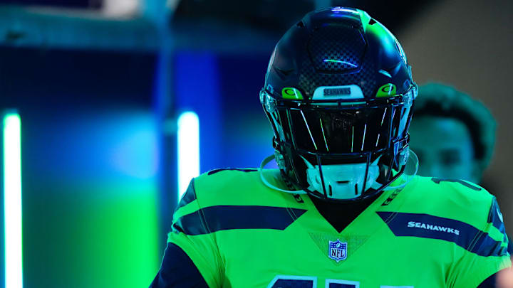 SEATTLE, WASHINGTON - DECEMBER 15: DK Metcalf #14 of the Seattle Seahawks walks out to the field to warm up before a game against the San Francisco 49ers at Lumen Field on December 15, 2022 in Seattle, Washington.