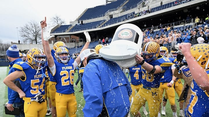 Marion Local players dump water on head coach Tim Goodwin after winning the 2023 OHSAA Division VII state championship game.