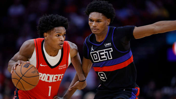 Jan 1, 2024; Houston, Texas, USA; Houston Rockets guard Amen Thompson (1) dribbles past Detroit Pistons forward Ausar Thompson, (9) at Toyota Center. /Carmen Mandato/Getty Images