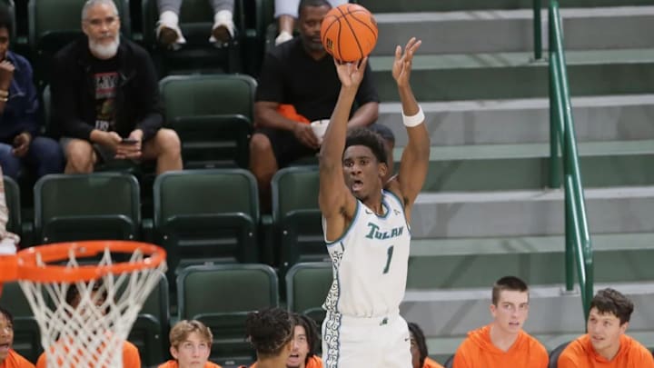 Tulane Green Wave forward Kaleb Banks (1) hits a three point shot over Louisiana Christian Wildcat Corey Lombard (22) tip-off at Avron B. Fogelman Arena on the Tulane campus in New Orleans, Monday, Nov. 4, 2024.