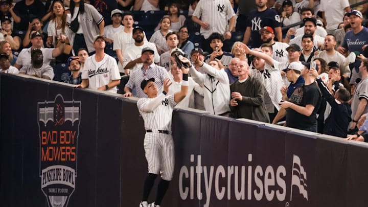 Judge was bumped by a fan while attempting to catch a ball in foul territory. 
