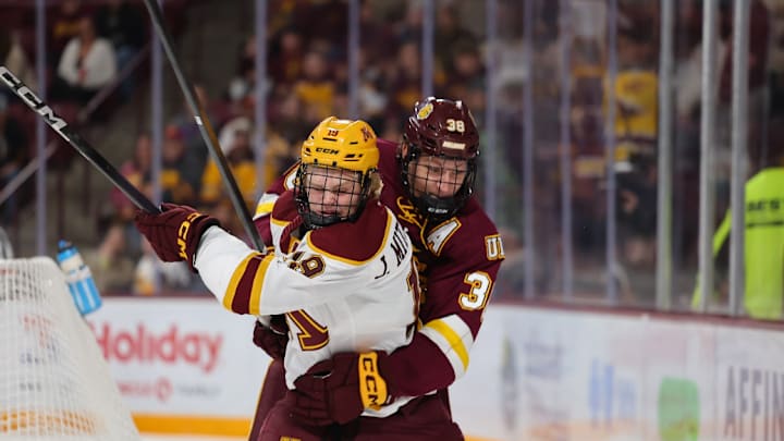 Gophers veteran forward John Middlestadt fighting for the puck against UMD. Gophers veteran forward John Middlestadt fighting for the puck against UMD.