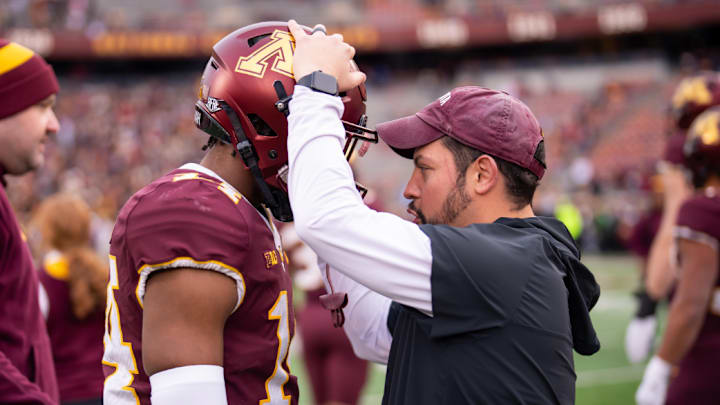 Danny Collins (right) with Gophers safety Kerry Brown (left).