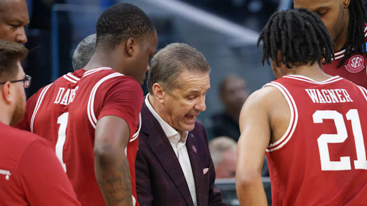 Arkansas Razorbacks coach John Calipari draws up a play during a break in the action against the Texas Tech Red Raiders in the NCAA Sweet 16
