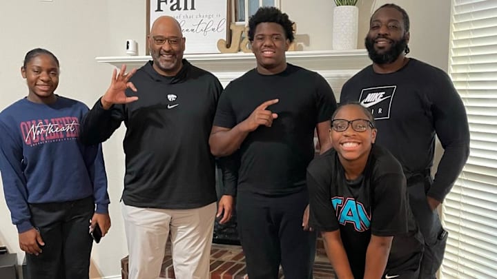 Kansas State defensive line coach Buddy Wyatt, Johnnie Fitzgerald, and his family during a home visit. Kansas State defensive line coach Buddy Wyatt, Johnnie Fitzgerald, and his family during a home visit.