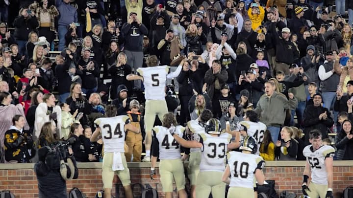 Adrian quarterback Colton Miller (5) celebrates with the fans following the Class 1 final game against Hamilton Penney. Adrian quarterback Colton Miller (5) celebrates with the fans following the Class 1 final game against Hamilton Penney.
