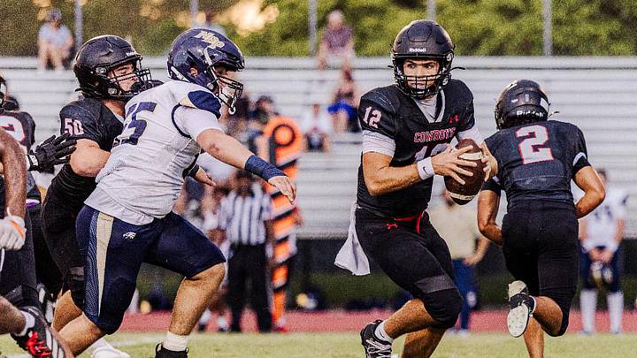 Cooper City quarterback Nick Dyer (12) looks for a receiver during the Cowboys' season-opener against North Broward Prep. He completed 12 of 19 passes for 298 yards and three touchdowns and ran for another score in a 48-21 victory. Cooper City quarterback Nick Dyer (12) looks for a receiver during the Cowboys' season-opener against North Broward Prep. He completed 12 of 19 passes for 298 yards and three touchdowns and ran for another score in a 48-21 victory.