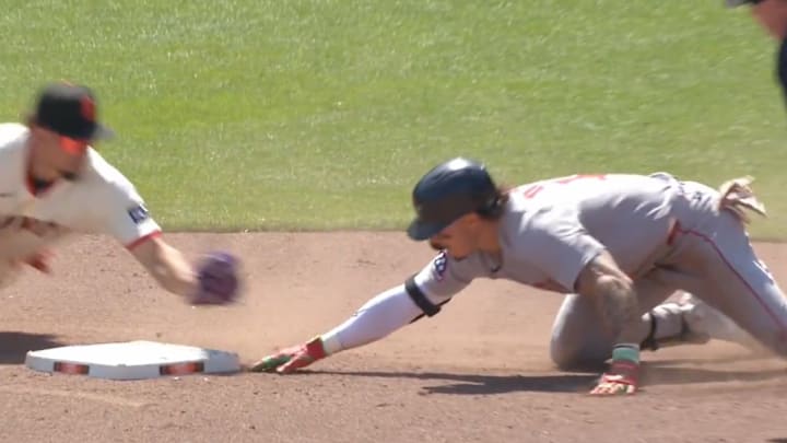Boston Red Sox OF Jarren Duran tries to get back to second base after sliding while San Francisco Giants SS Willy Adames attempts to tag him out. 