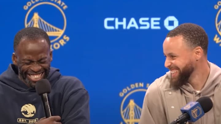 Curry and Green laughing while speaking to reporters after the Warriors' game. 