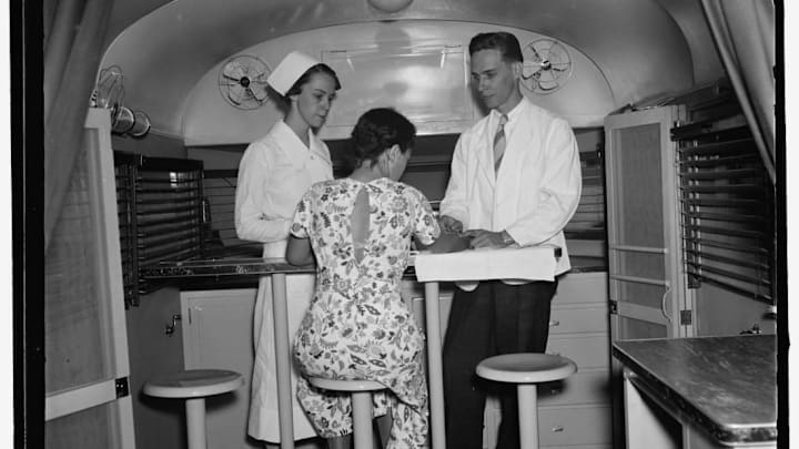A young woman gets tested for syphilis in a "trailer-laboratory" in Washington, D.C. in 1937.