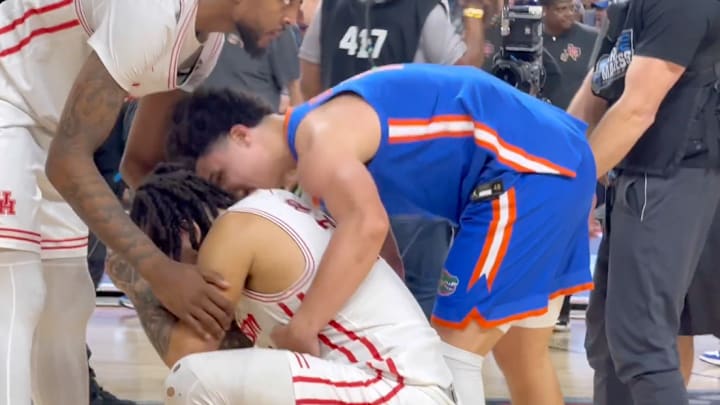 Walter Clayton Jr. consoles Emmanuel Sharp after the national title game. 