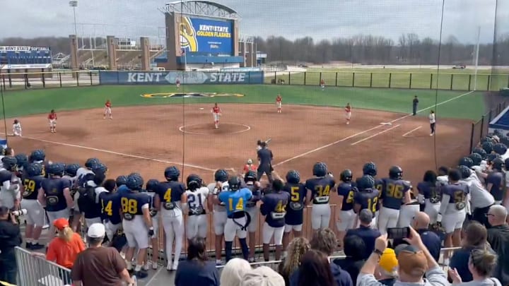 The Kent State football team showed up in full pads to cheer on the softball team.