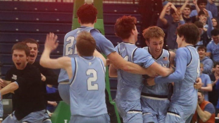 Members of the York High School boys basketball team celebrate after beating top-seeded Medomak Valley in last year's Class B South championship game at The Expo in Portland, Maine.