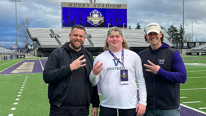 Reis Russell, a UW offensive-line commit, shares a moment with line coaches Michael Switzer and Michael Brewster. 