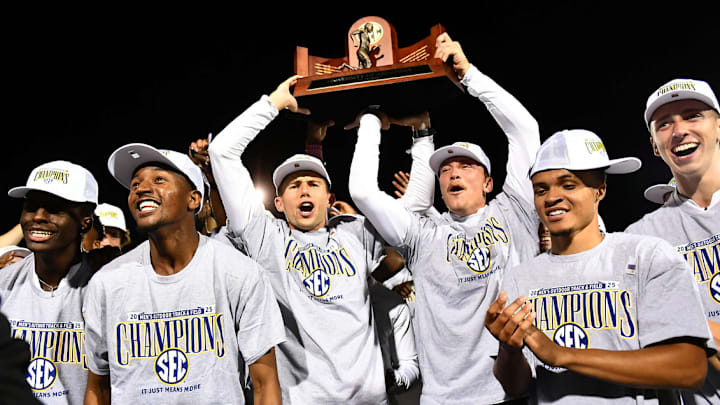 The Arkansas Razorbacks hoist the team trophy after winning the 2025 SEC Men's Track & Field Championship in Lexington, Ky.