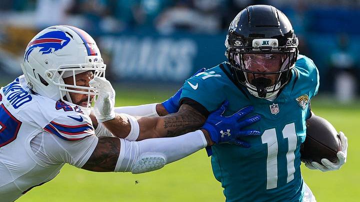 Buffalo Bills cornerback Christian Benford (47) tries to tackle Jacksonville Jaguars wide receiver Parker Washington (11) during the third quarter in an NFL football AFC Wild Card playoff matchup, Sunday, Jan. 11, 2026, in Jacksonville, Fla. Bills lead 10-7 at the half over the Jaguars. The Bills defeated the Jaguars 27-24.