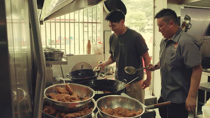 Chef Frankie Gaw cooking with another chef in a kitchen. Chef Frankie Gaw cooking with another chef in a kitchen.