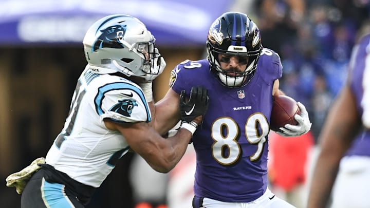 Nov 20, 2022; Baltimore, Maryland, USA; Baltimore Ravens tight end Mark Andrews (89) stiff arms Carolina Panthers safety Jeremy Chinn (21) during the second half at M&T Bank Stadium. 