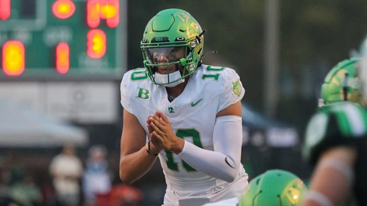 Dayton Raiola taking a snap in high school