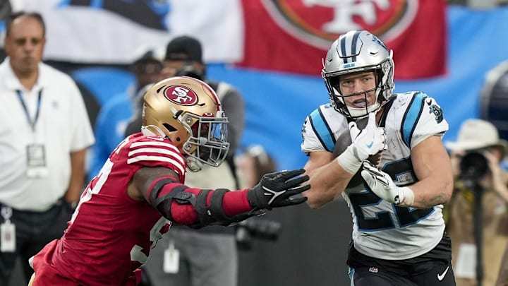 Oct 9, 2022; Charlotte, North Carolina, USA; Carolina Panthers running back Christian McCaffrey (22) tries to elude San Francisco 49ers defensive end Kemoko Turay (53) during the second half at Bank of America Stadium.