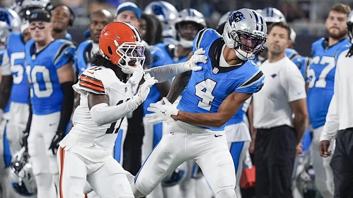 Aug 8, 2025; Charlotte, North Carolina, USA; Cleveland Browns cornerback Tony Brown II (11) breaks up a pass for Carolina Panthers wide receiver Tetairoa McMillan (4) during the second quarter at Bank of America Stadium. Mandatory Credit: Jim Dedmon-Imagn Images