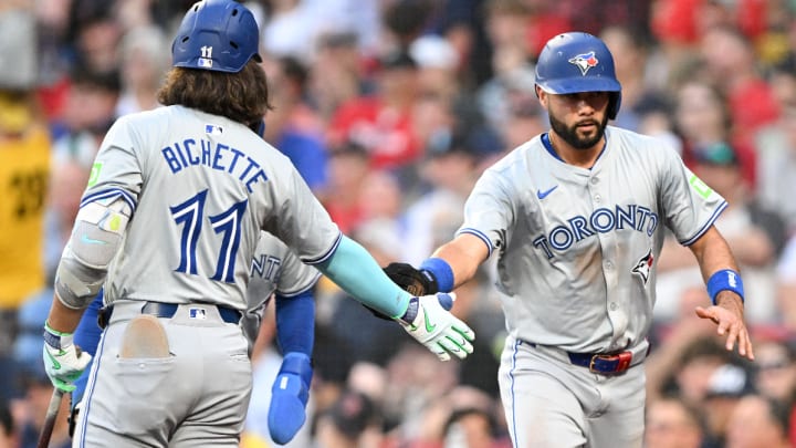 Jun 25, 2024; Boston, Massachusetts, USA; Toronto Blue Jays third baseman Isiah Kiner-Falefa (7) high-fives shortstop Bo Bichette (11) after scoring a run against the Boston Red Sox during the third inning at Fenway Park. Mandatory Credit: Brian Fluharty-USA TODAY Sports