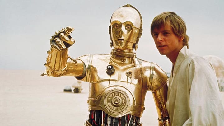 Star Wars: Episode IV - A New Hope. C-3PO played by Anthony Daniels on Tatooine with Luke Skywalker (Mark Hamill). Image Credit: StarWars.com