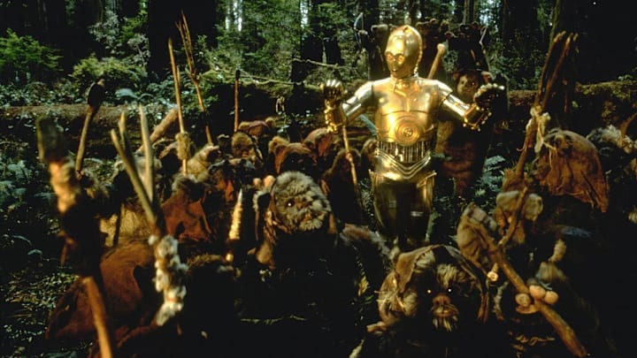 Star Wars: Episode VI - Return of the Jedi. C-3PO played by Anthony Daniels on Endor with the Ewoks. Image Credit: StarWars.com