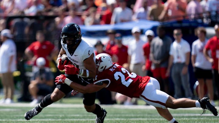 Miami Redhawks defensive back Jackson Pons (22) tackles Cincinnati Bearcats tight end Joe Royer (11) in the first quarter of the College Football game at Yager Stadium in Cincinnati on Saturday, Sept. 14, 2024.