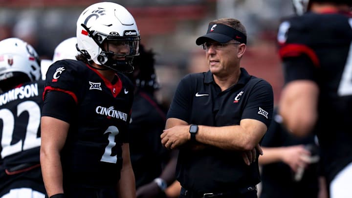 Cincinnati Bearcats head coach Scott Satterfield speaks with Cincinnati Bearcats quarterback Brendan Sorsby (2) before the College Football game between the Cincinnati Bearcats and the Houston Cougars at Nippert Stadium in Cincinnati on Saturday, Sept. 21, 2024. Cincinnati Bearcats head coach Scott Satterfield speaks with Cincinnati Bearcats quarterback Brendan Sorsby (2) before the College Football game between the Cincinnati Bearcats and the Houston Cougars at Nippert Stadium in Cincinnati on Saturday, Sept. 21, 2024.